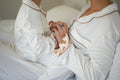 Toddler and mum in matching Nuvea Teddy bamboo pyjamas with teddy bear print cuffs, reading a bedtime story in bed